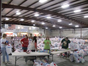 Volunteers preparing bags of toys for distribution