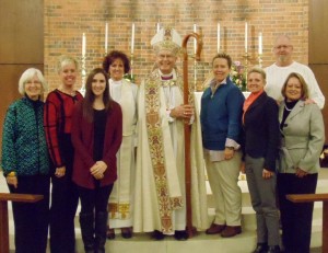 The Rev. Karen Calafat and Bishop High with Calafat's family.