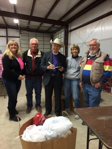 Bishop High, center, with (l-r) Jacque Gordon, president of Hood County Christmas for Children; Ian Moore, Barb Snyder, and Norm Snyder, all of the Episcopal Church of the Good Shepherd, Granbury.